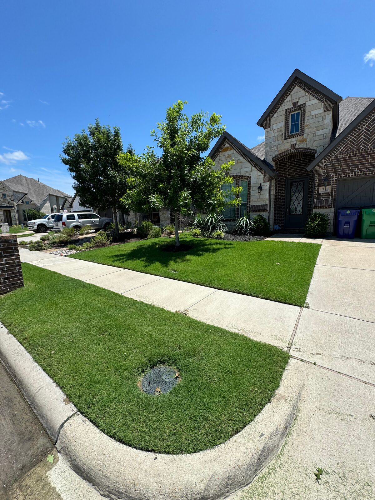 Manicured corner lot lawn with crisp sidewalk edges