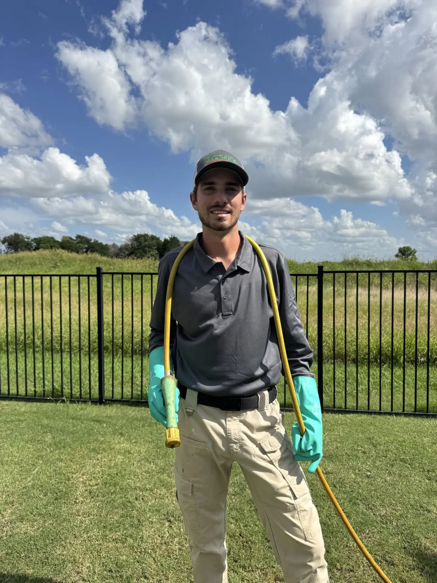 Brandon Porter, owner of Porter's Fertilization & Weed Control, treating a lawn in Rockwall, Texas