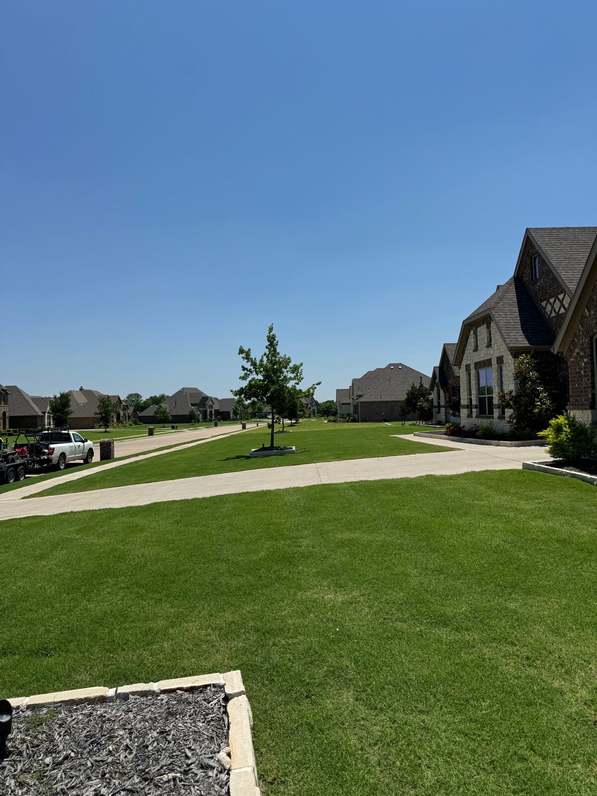 Neighborhood front lawn with clean landscape beds